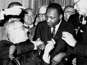 Martin Luther King, Jr. and Lyndon Johnson as the Civil Rights Act is signed